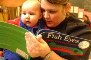 Photo-Colin-McConnellToronto-Star-via-Getty-Images-Mom-reading-to-baby-300x197