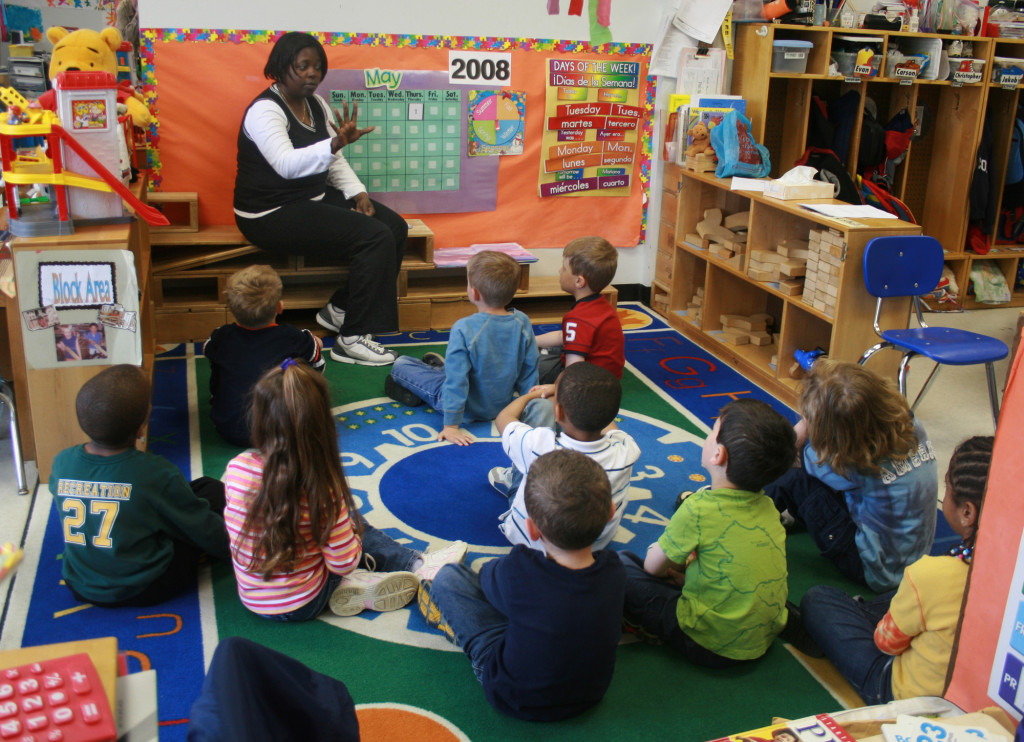 Teacher teaching students in an early childhood setting - WikimediaCommons