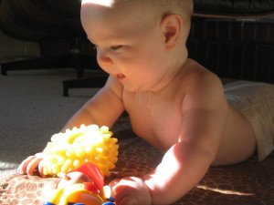 Baby_playing_-_by_Patrick_Jayne_and_Thomas-WikimediaCommons-300x225