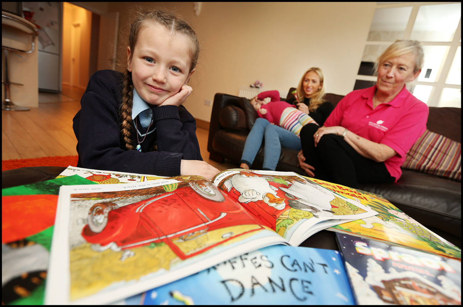 Leah-Martin-7-reads-to-her-mum-sister-and-grandmother-showing-the-benefits-of-her-time-with-PCHP-Steve-Humphreys